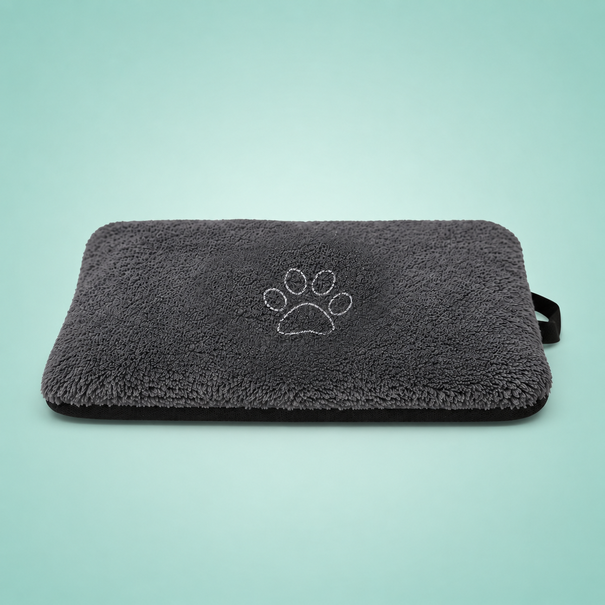 Gray pet mat with a paw print design on a light blue background