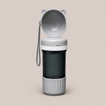 Gray portable trash can with open lid on a beige background