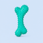 Green textured dog toy on a light purple background