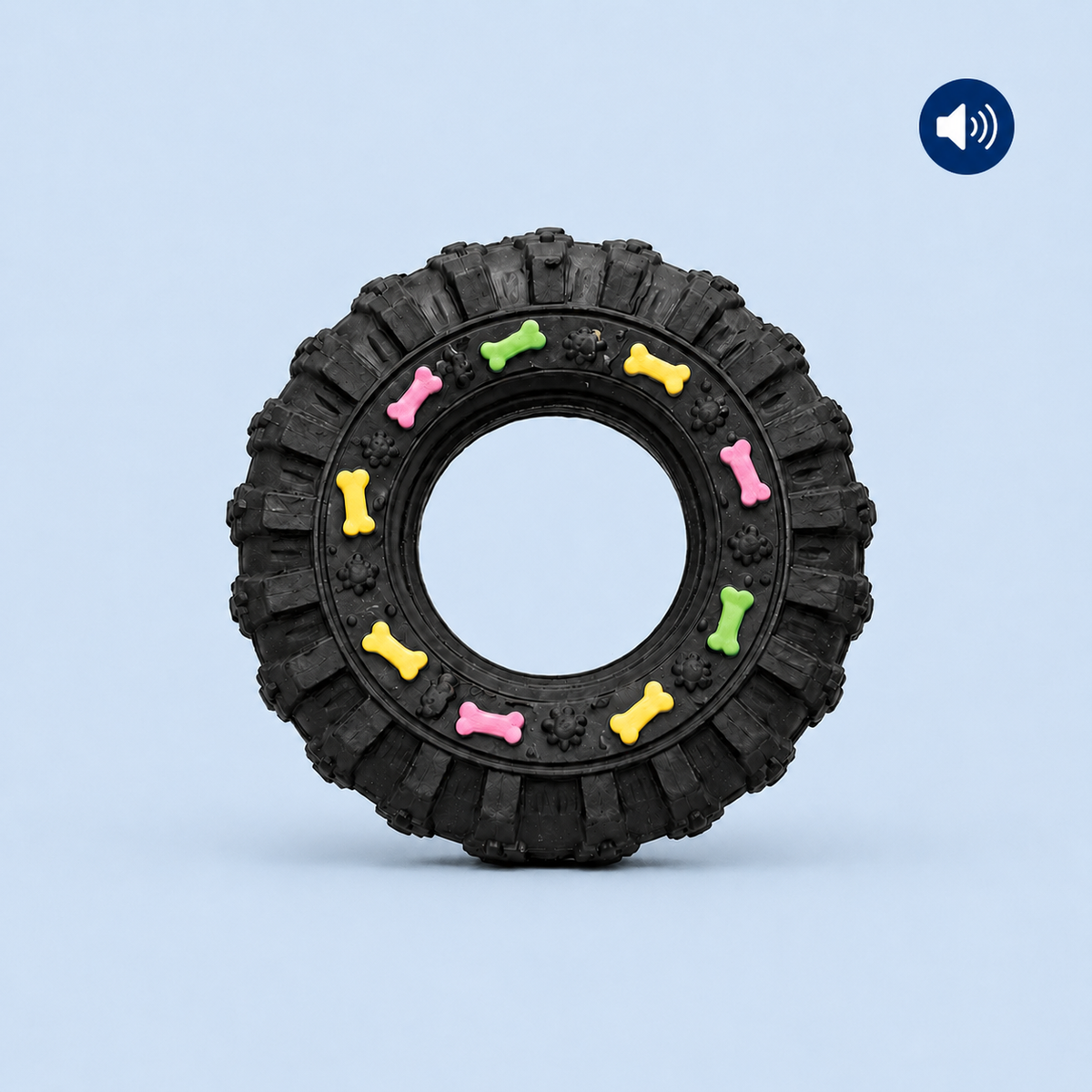 Black tire-shaped dog toy with colorful bones on a light blue background